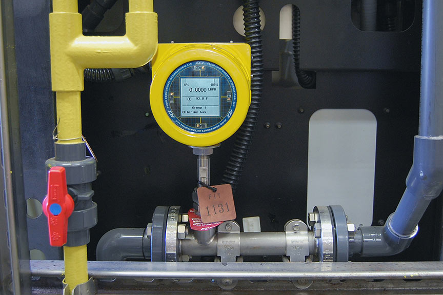 FCI ST100L flow meter inserted in piing at water treatment facility - inside cabinet